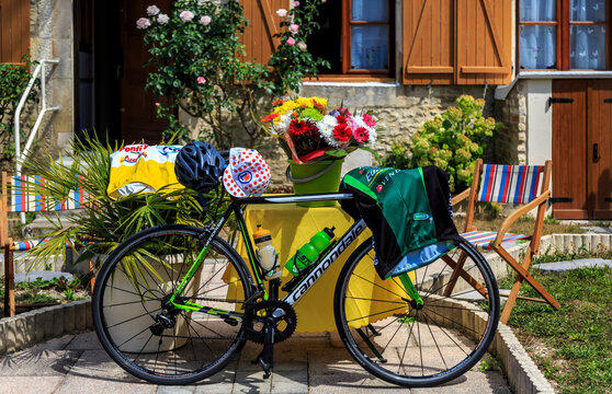 Celles-sur-Ource, France - July 26th, 2022: A bicycle covered by specific objects and clothes is in front of a house during stage 4 of Le Tour de France Femmes 2022.