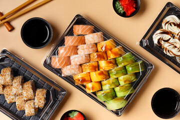 Set of sushi rolls in plastic packages on a light background, top view.