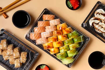 Fotobehang Set of sushi rolls in plastic packages on a light background, top view. © Наталья Марная