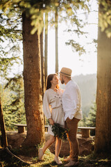 Young couple in love in sunny forest