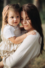 Young mother with her little daughter outdoors
