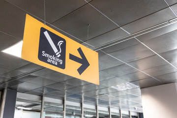 Direction signage to smoking area at airport terminal departure hall