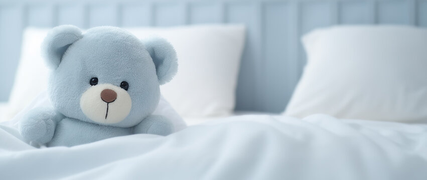 Get Well Hugs: Comforting Blue Teddy Bear Stuffed Toy Sitting on Bed, Sending Warm Wishes for a Speedy Recovery.