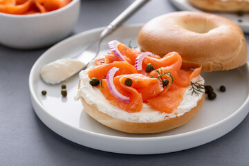 Plain bagel with salmon and cream cheese with fresh dill and capers