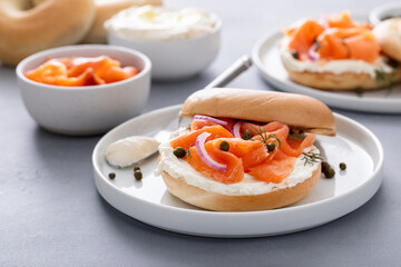 Plain bagel with salmon and cream cheese with fresh dill and capers