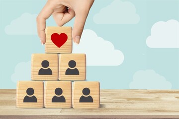 Increasing customer concept. Wooden cubes with heart icon