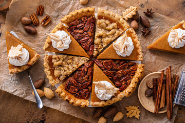 Variety of Thanksgiving pie slices on parchment paper © fahrwasser