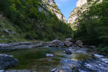 clear turquoise stream of rio bellos in Anisclo Canyon in Pyrenees Mountains, Ordesa National Park, Aragon, Huesca, Spain