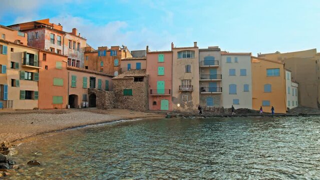 Cinematic view over the colorful houses of Saint -Tropez on the French Riviera. Colorful historical Old Town of Saint Tropez, a popular resort on the sea shore on a golden sunset.