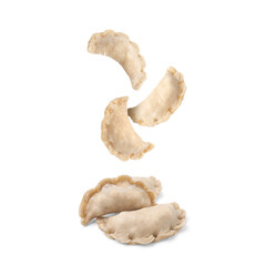 Many raw dumplings (varenyky) with cottage cheese falling on white background
