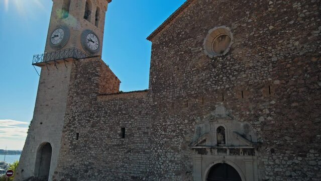 Clock and bell tower of Church of Notre Dame D'esperance in Cannes. Famous landmark at a resort town on the French Riviera, Cote D'Azur.
