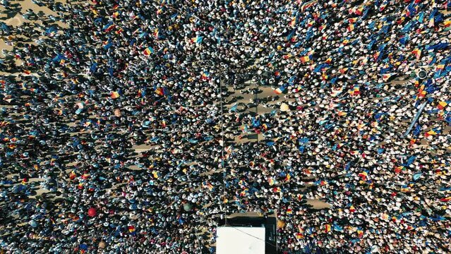 Aerial drone view of the rally in support of the country's European integration in Chisinau, Moldova. Thousands of people in the city downtown, greenery, EU and national flags