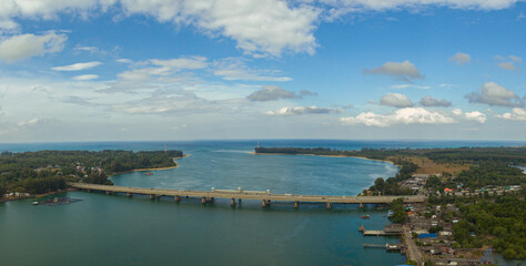 .Aerial view beautiful Sarasin bridge on the blue sea..Sarasin bridge is important route connecting by land..Scene of white cloud in blue sky and green sea..the bridge connect Phuket to Phang Nga..