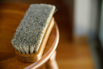 hand with leather brush.