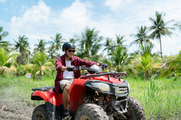 Obraz premium Quad bike in dust cloud, sand quarry on background. ATV Rider in the action.