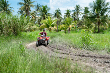 Fototapeta premium Quad bike in dust cloud, sand quarry on background. ATV Rider in the action.