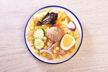 Tuna salad with corn, lettuce, red onions, boiled egg,  radish, cucumber and canned tuna.