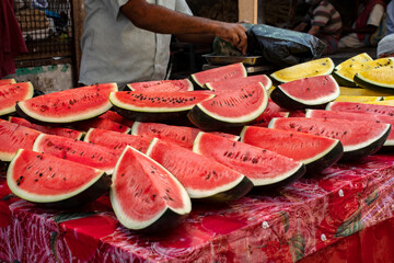 A man of muslim religion selling watermelon fruits at the Zakaria street at the time of Ramadan.