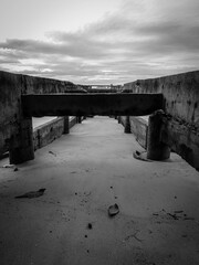 a ruin of a concrete jetty by the beach