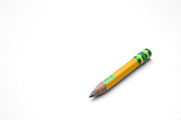 Well worn Used up Short No.2 Yellow Pencil Isolated with Transparent shadow at an angle