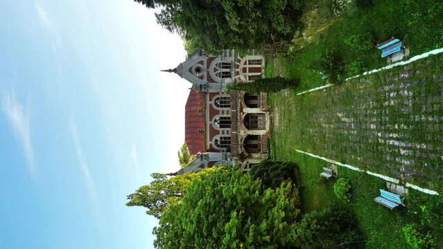 Drone vertical view of the Pommer Mansion in Taul, Moldova. Old abandoned building with greenery around it and garden in front of it