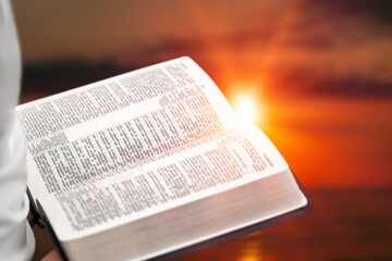 Fototapeta premium Christian person holds bible books in hands.