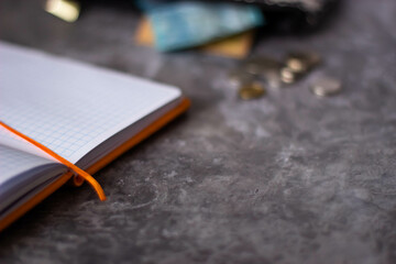 Tenge. Kazakh money. Notebook on a gray background. Banknotes and coins