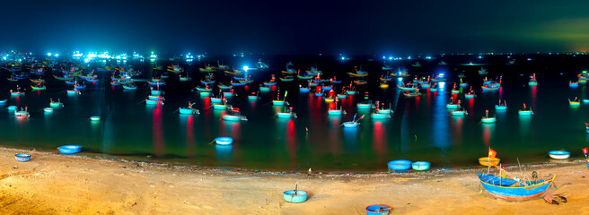 Mui Ne fishing village at night with hundreds of boats anchored to avoid storms, this is a beautiful bay in central Vietnam
