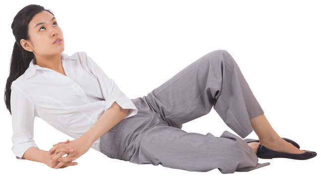 Digital png photo of happy asian businesswoman lying down on transparent background