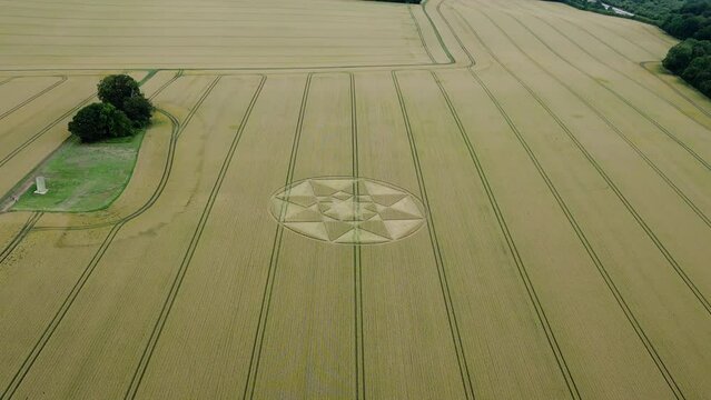 Golden agricultural wheat field crop circle aerial view over Micheldever, Hampshire strange circular pattern
