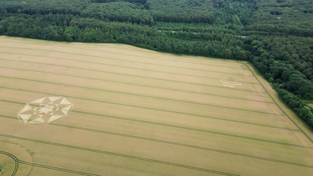 Aerial view flying across Micheldever crop circle geometric designs on Hampshire agricultural field