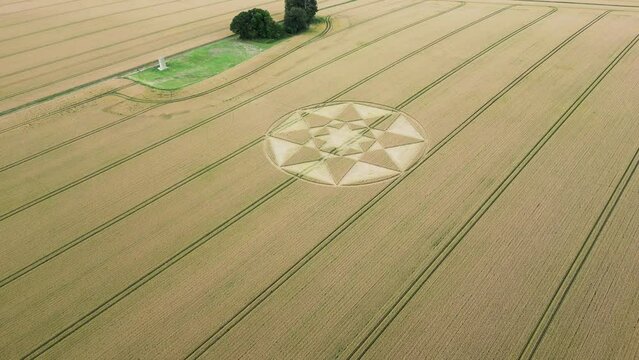Aerial view towards Micheldever circular crop circle pattern on golden Hampshire agricultural wheat filed