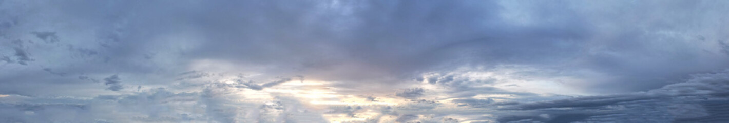 Panorama view of the beautiful blue sky bathed in soft sunlight presents a serene and picturesque landscape.