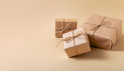 Gifts in eco-friendly paper packaging on a trendy beige background. Layout mockup copy space concept minimalism