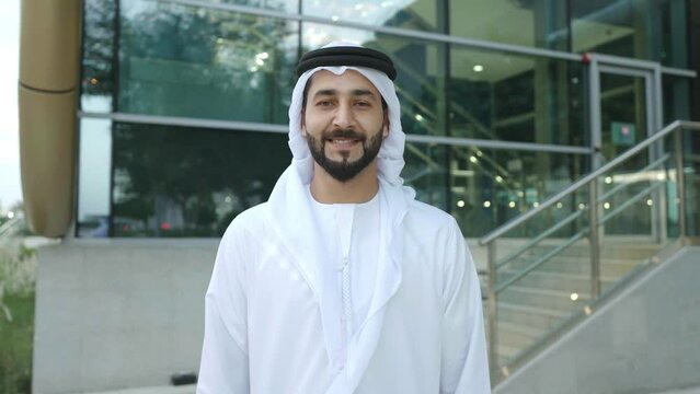 Arab man on kandura looking at the camera Emirati UAE businessman smiling while looking at the front wearing Middle Eastern clothing