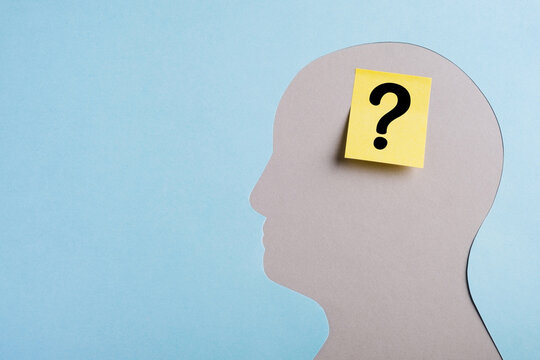 Mental health concept. Head silhouette with question mark on yellow sticker. Alzheimer disease, memory loss or dementia. Top view, copy space