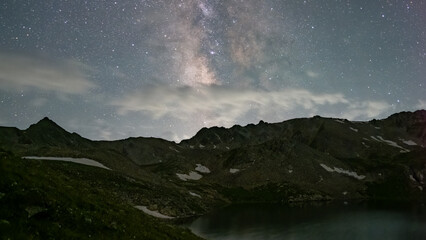 the starry sky in the mountains. night in the mountains. stars over a mountain lake