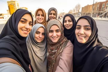 Fotobehang A group of young muslim women wearing headscarves having fun together, Generative AI © S A F I Y A