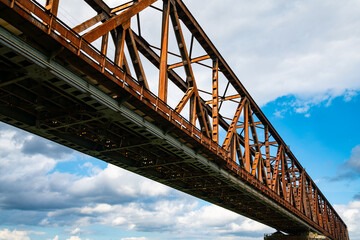 Historic railway bridge over river Rhine in Duisburg, Germany. Steel rivet construction with...
