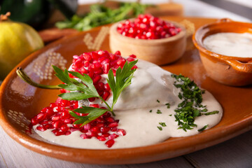 Chile en Nogada, Typical dish from Mexico. Prepared with poblano chili stuffed with meat and fruits and covered with a walnut sauce. Named as the quintessential Mexican dish for national holidays.