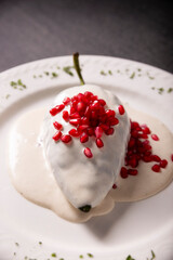 Chile en Nogada, Typical dish from Mexico. Prepared with poblano chili stuffed with meat and fruits and covered with a walnut sauce. Named as the quintessential Mexican dish for national holidays.
