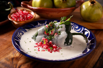 Chile en Nogada, Typical dish from Mexico. Prepared with poblano chili stuffed with meat and fruits and covered with a walnut sauce. Named as the quintessential Mexican dish for national holidays.