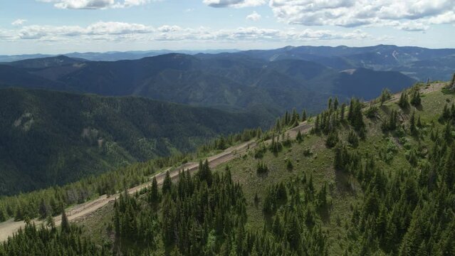 Aerial revealing over a mountain side of a ski resort in Kellogg Idaho in summer