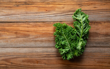 Kale placed against a wooden background.
