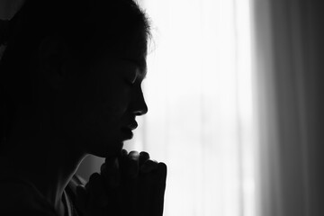 silhouette of Religious young woman praying to God in the morning, spirtuality and religion, Religious concepts