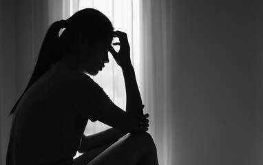 Young  women sitting in dark room feeling pain with life problem.  suffering from husband violence, Stop violence against and sexual abuse women, domestic violence, anti human trafficking.