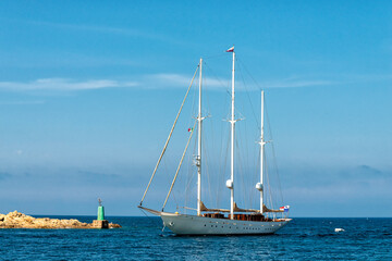 Fototapeta premium luxury sailing yacht entering a harbour in the Mediterranean Sea