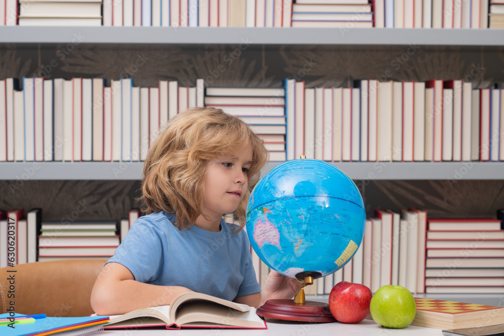 Aufkleber school pupil looking at globe in library, geography lesson. school child studying in classroom at el