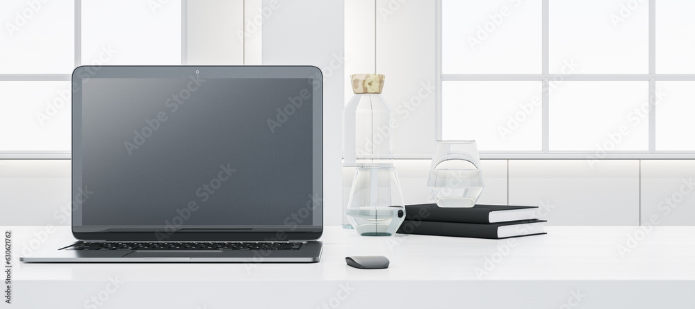 Poster close up of wide white office desk with empty laptop screen, supplies and other objects. blurry conc