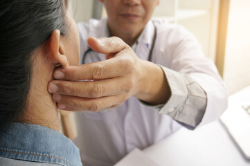 Fototapeta premium Doctor checking pulse woman patient for heartbeat. Health care concept